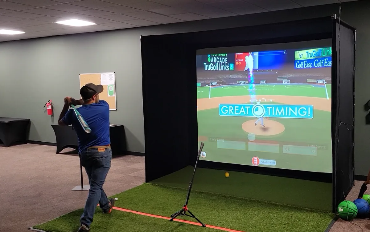 Guest batting during the Rally Baseball simulator game at Sim Time